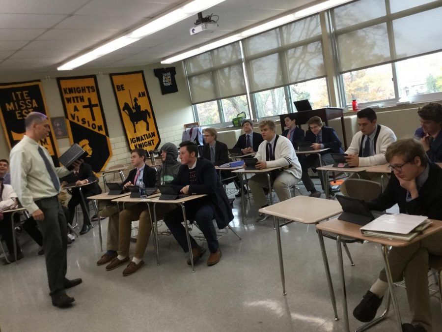 Mr. Hoelperl of the Theology Department teaches a lesson to one of his junior classes using the iPads.  