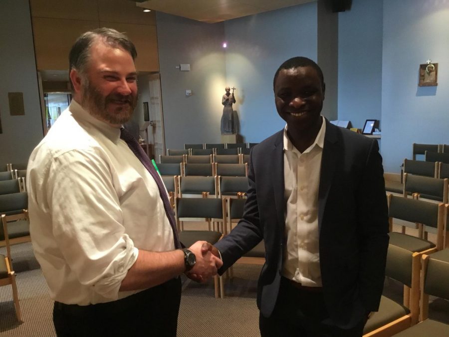 Rwandan refugee Ninteretse Jean-Pierre told the students of McQuaid Jesuit his story of  changing from a refugee who had nothing to an outstanding real estate lawyer. Theology teacher Mr. Matthew Whelehan '96 interacts and talks with Ninteretse Jean-Pierre. 