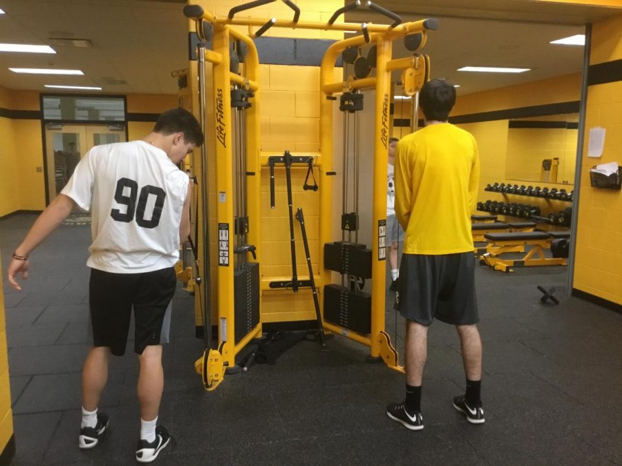 Erik+Johnson+18+and++Noah+Campanelli+19+perform+arm+related+workouts+Thurday%2C+in+the+McQuaid+Jesuit+weight+room.+Johnson+and+Campanelli+will+play+valuable+roles+for+the+baseball+team++this+season.