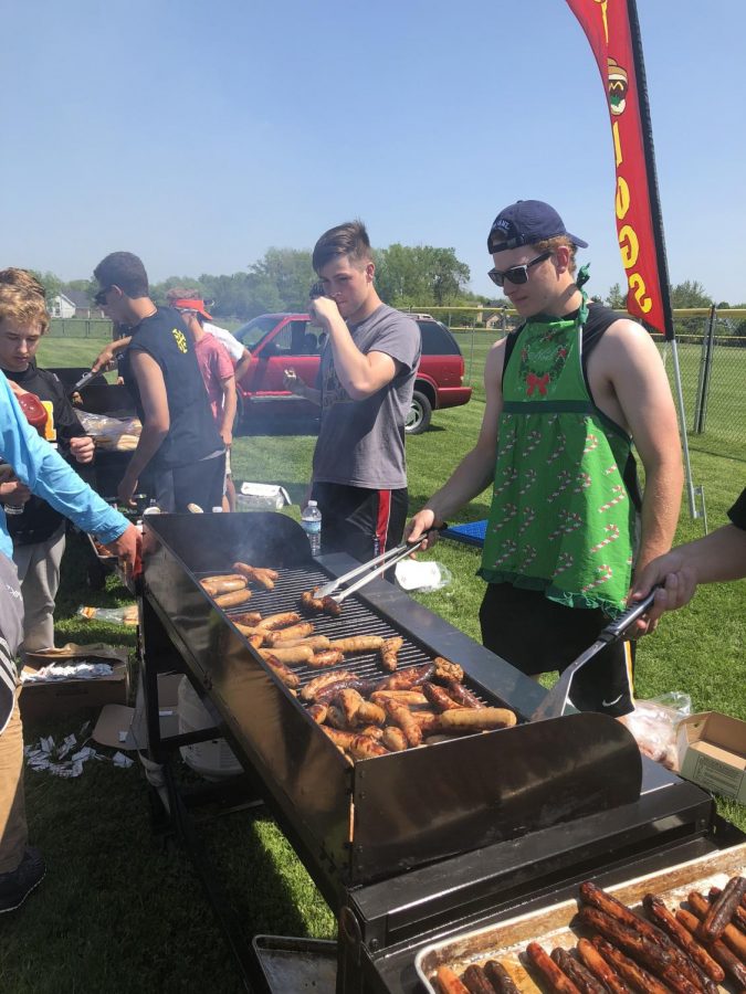 Seniors grill hot dogs and sausages for the entire student body.  For the first time since 2015, as a schoolwide cookout returns to McQuaid Jesuit.