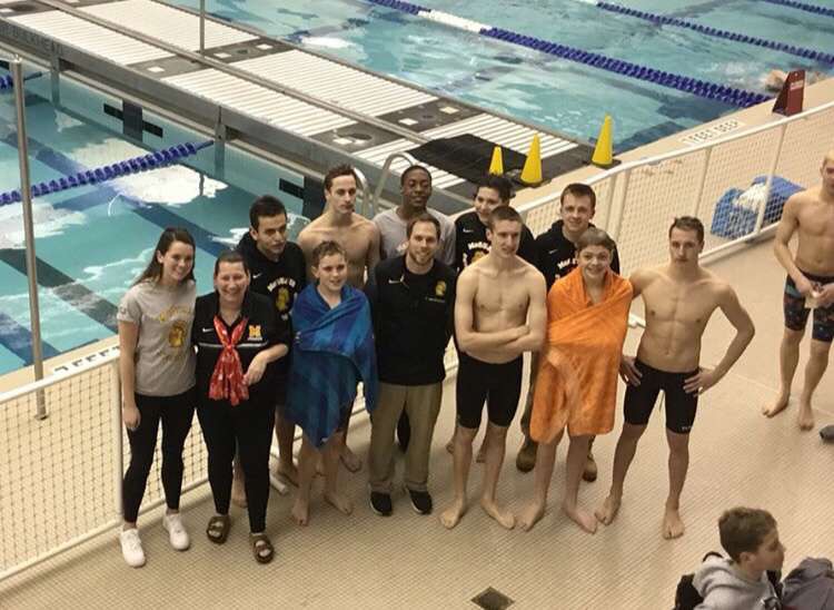 Last+years+McQuaid+Jesuit+swim+team+poses+for+a+picture+at+a+meet.+