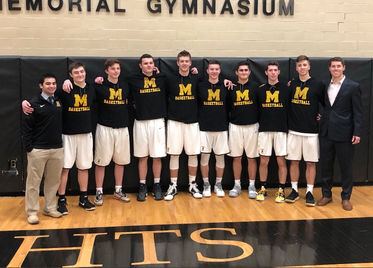McQuaid+Varsity+Basketball+Knights+take+a+picture+with+head+coach+Jack+Leasure%2C+04%2C+on+senior+night.+