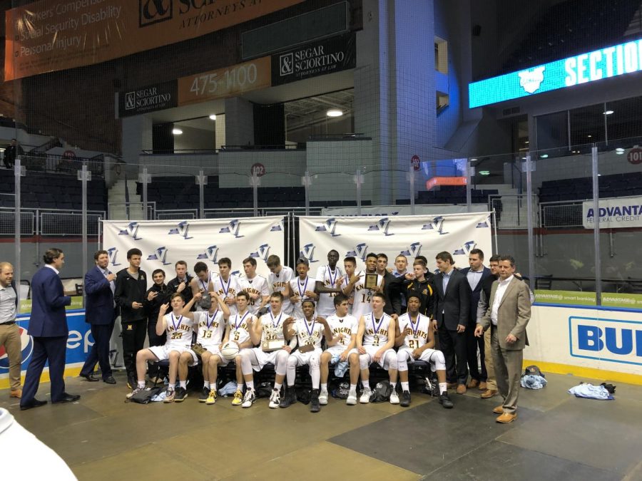 The varsity basketball team celebrates their sectional title.  The Knights defeated UPrep 81-75 at Blue Cross Arena.