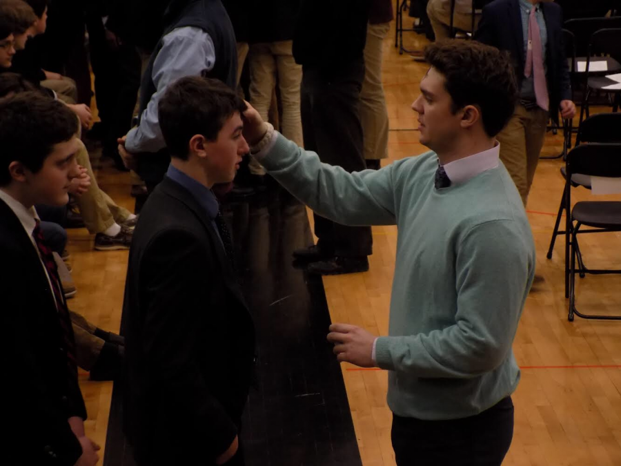 Ashes are applied to students foreheads in the John H. Ryan, Jr., Memorial Gymnasium on the first Wednesday of Lent