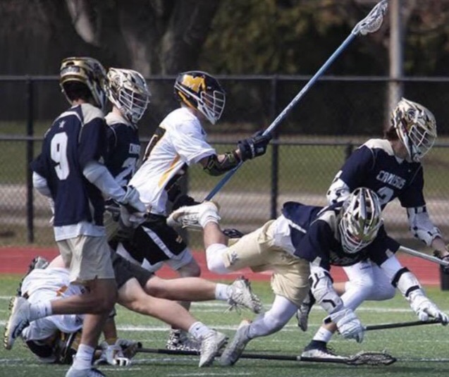 Junior Defender Ryan Martin weaves through a sea of Canisius attackers. The Knights were victorious against their rivals from Bufflao, winning by a score of 13-4. 