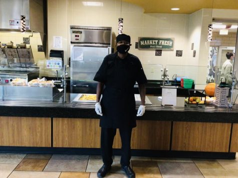 Mr. Roger Henry mans his station in the McQuaid cafeteria. Right before the first lunch rush, he gets his last preparations in for burgers and fries.