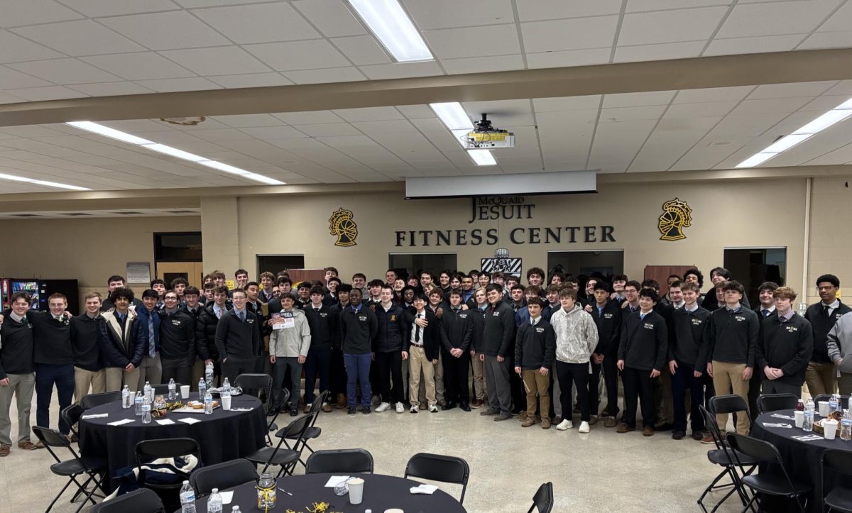 The McQuaid Jesuit seniors take a group picture after enjoying their breakfast.